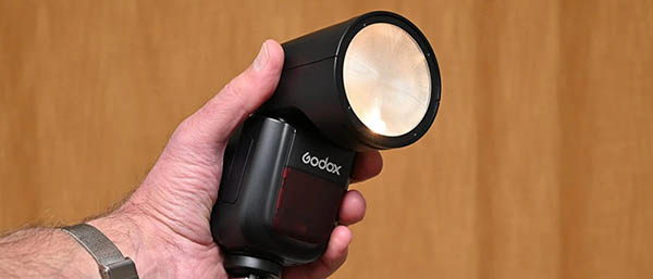 Накамерная вспышка Godox V1 с круглой оптической головкой и включенным светодиодным моделирующим светом